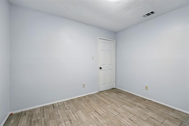 12318 Amado Dr, Houston, TX 77065 - empty room with wood tiled floors and baseboards