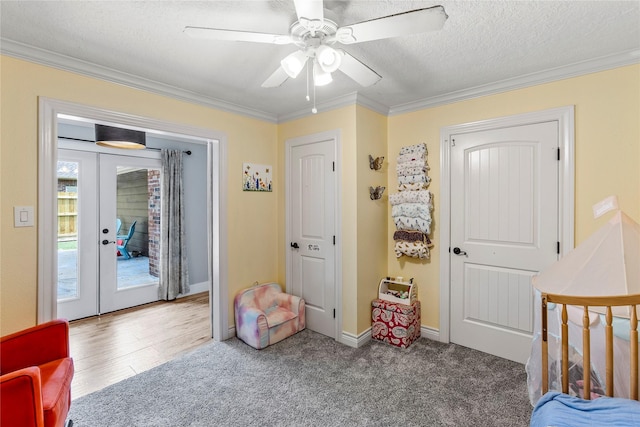 bedroom featuring crown molding, access to exterior, french doors, a textured ceiling, and a ceiling fan