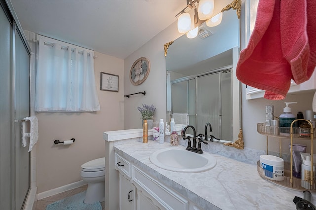 1745 15th St, Hempstead, TX 77445 - bathroom featuring a shower stall, vanity, toilet, baseboards, and tile patterned floors