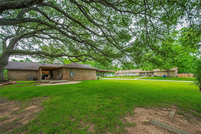 1745 15th St, Hempstead, TX 77445 - view of grassy yard featuring a patio