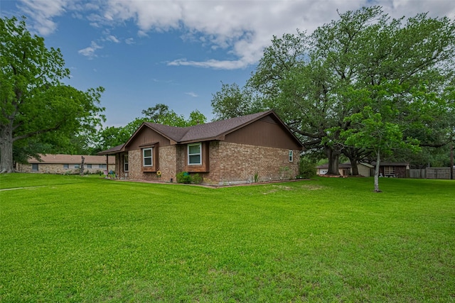 1745 15th St, Hempstead, TX 77445 - view of home's exterior featuring a yard and brick siding