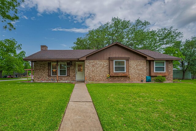 1745 15th St, Hempstead, TX 77445 - ranch-style home featuring brick siding, a front yard, and a chimney