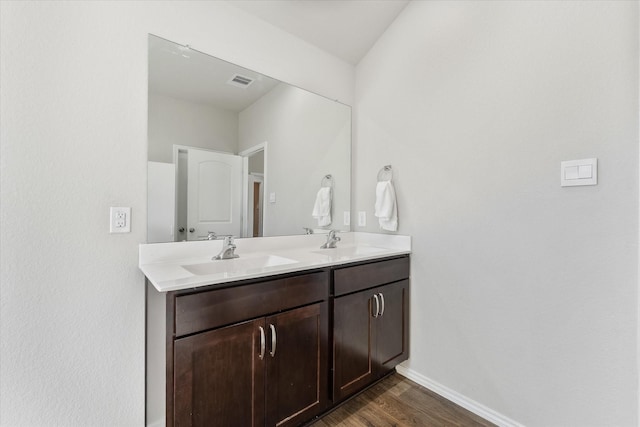 12225 Trumpetfish Dr, Conroe, TX 77304 - bathroom with wood finished floors, baseboards, and double vanity