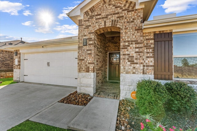 12225 Trumpetfish Dr, Conroe, TX 77304 - entrance to property featuring stone siding, concrete driveway, a garage, and brick siding