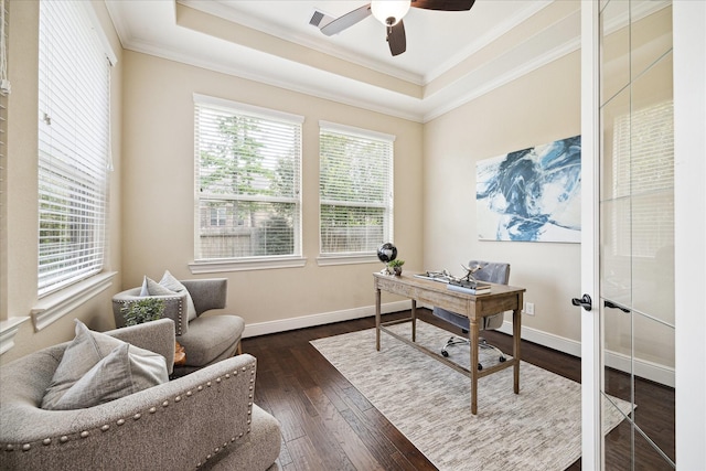 home office with crown molding, a raised ceiling, dark wood-type flooring, ceiling fan, and baseboards