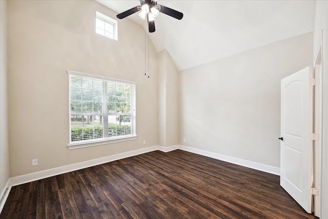 empty room with dark wood-style floors, a ceiling fan, baseboards, and high vaulted ceiling