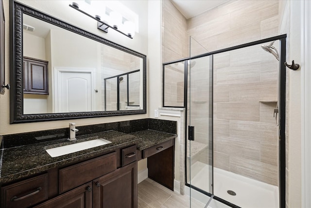 full bath featuring a shower stall and vanity