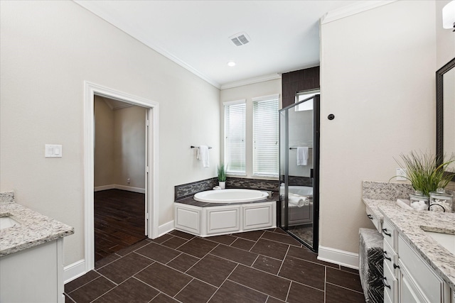 full bathroom featuring two vanities, crown molding, a bath, baseboards, and a shower stall