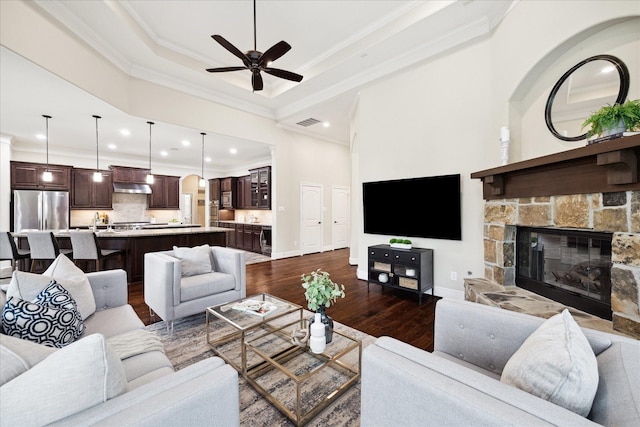 living area with dark wood-style floors, ornamental molding, recessed lighting, a ceiling fan, and a fireplace