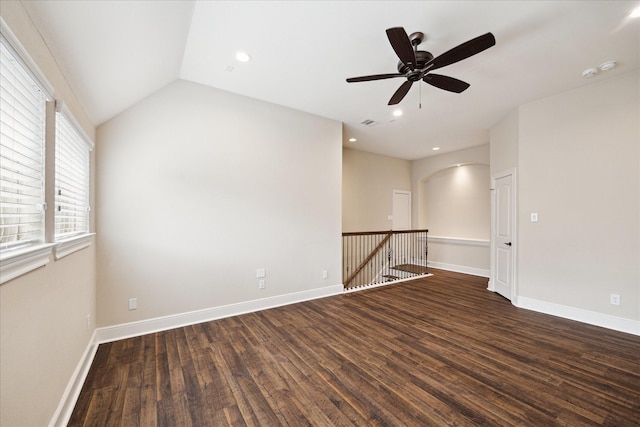 spare room featuring wood finished floors, ceiling fan, baseboards, recessed lighting, and vaulted ceiling