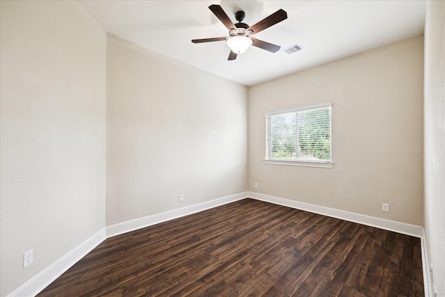 empty room featuring dark wood-style floors, baseboards, and a ceiling fan
