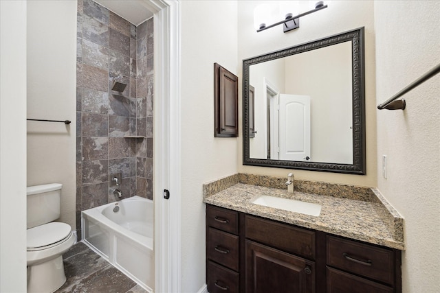 bathroom with toilet, vanity, and shower / bath combination