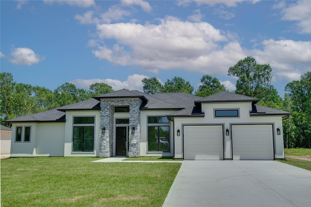 1156 Rd 6604, Dayton, TX 77535 - prairie-style home with concrete driveway, stucco siding, a garage, and a front lawn