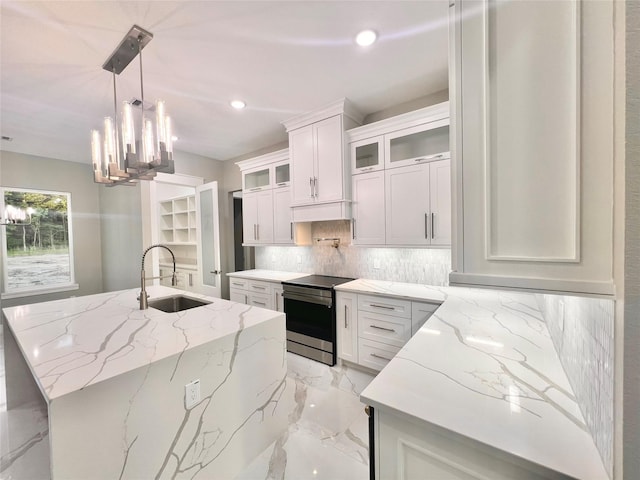 1156 Rd 6604, Dayton, TX 77535 - kitchen featuring stainless steel range with electric stovetop, a sink, tasteful backsplash, an island with sink, and recessed lighting