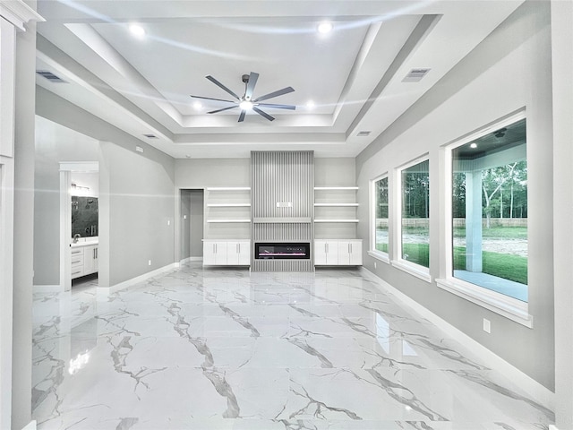 1156 Rd 6604, Dayton, TX 77535 - unfurnished living room with baseboards, a tray ceiling, a ceiling fan, marble finish flooring, and recessed lighting