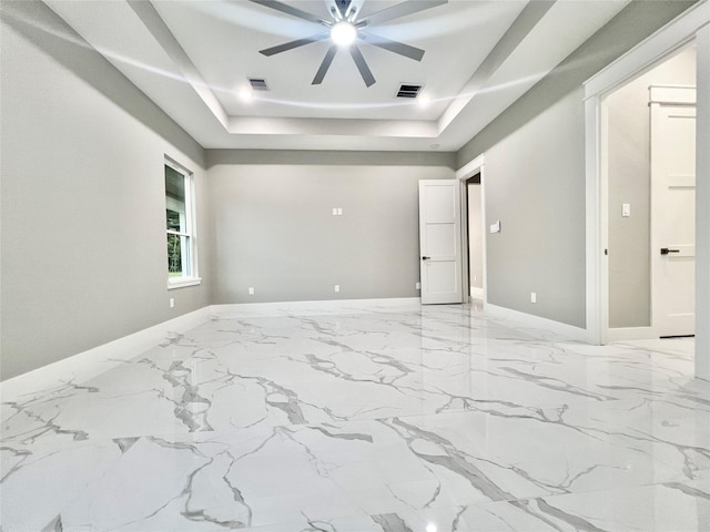 1156 Rd 6604, Dayton, TX 77535 - spare room with a raised ceiling, a ceiling fan, baseboards, and marble finish flooring