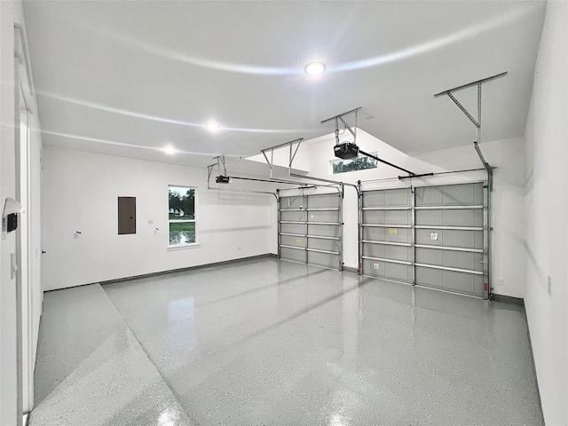 1156 Rd 6604, Dayton, TX 77535 - garage featuring electric panel, a garage door opener, and baseboards