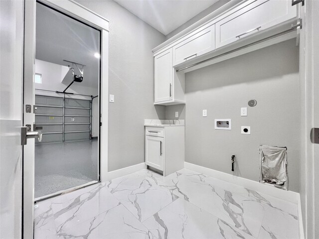 1156 Rd 6604, Dayton, TX 77535 - clothes washing area featuring electric dryer hookup, hookup for a washing machine, baseboards, cabinet space, and light marble finish floors