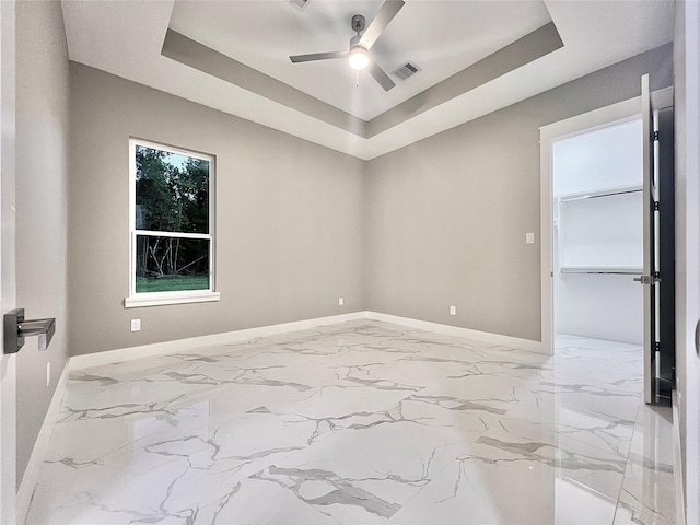 1156 Rd 6604, Dayton, TX 77535 - unfurnished room with baseboards, a tray ceiling, ceiling fan, and marble finish floors