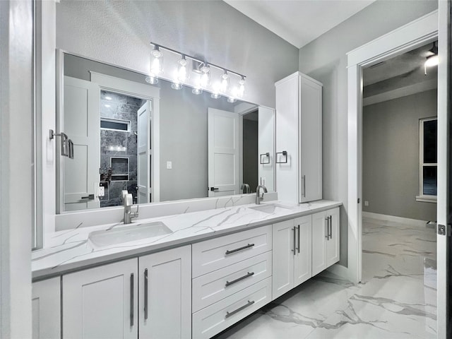 1156 Rd 6604, Dayton, TX 77535 - full bath with marble look tiles, double vanity, and baseboards