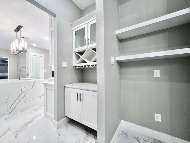 1156 Rd 6604, Dayton, TX 77535 - mudroom featuring light marble finish floors, a sink, baseboards, a chandelier, and recessed lighting