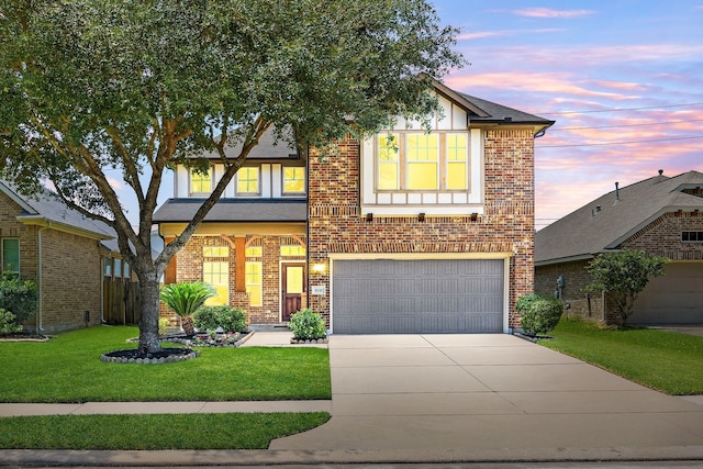 view of front of property featuring an attached garage, concrete driveway, a yard, and brick siding