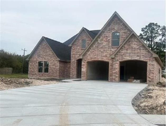 7925 Farrah St, Beaumont, TX 77707 - view of front of house with concrete driveway and a garage