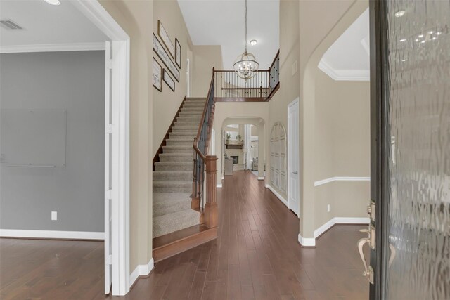 17306 Legend Brook Ct, Tomball, TX 77375 - entrance foyer featuring arched walkways, baseboards, stairway, ornamental molding, and dark wood finished floors