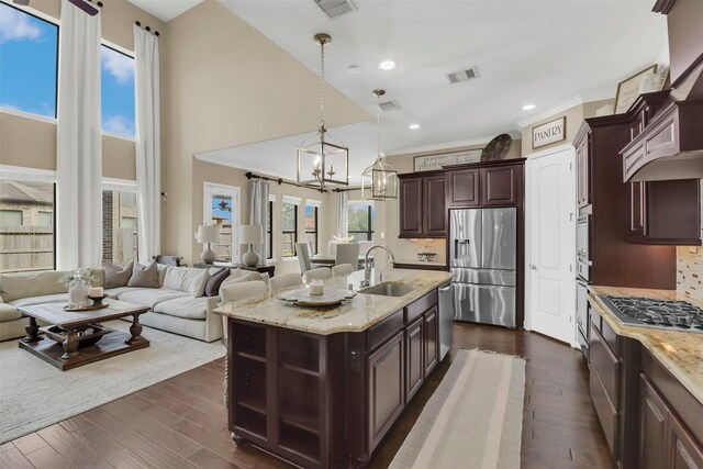 17306 Legend Brook Ct, Tomball, TX 77375 - kitchen featuring stainless steel appliances, a sink, open floor plan, backsplash, and a high ceiling
