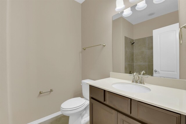 17306 Legend Brook Ct, Tomball, TX 77375 - bathroom with toilet, tiled shower, vanity, and baseboards