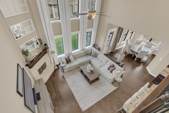 17306 Legend Brook Ct, Tomball, TX 77375 - living room featuring a high ceiling, wood finished floors, and ceiling fan