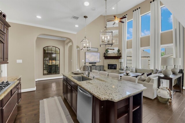 17306 Legend Brook Ct, Tomball, TX 77375 - kitchen with a sink, stainless steel dishwasher, arched walkways, dark wood finished floors, and ceiling fan