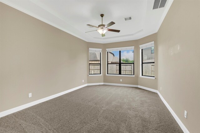 17306 Legend Brook Ct, Tomball, TX 77375 - empty room with carpet, a ceiling fan, a raised ceiling, baseboards, and crown molding