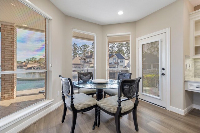 44 Logansport Ct, Montgomery, TX 77356 - dining room with light wood-type flooring, baseboards, recessed lighting, and a water view