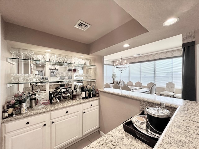 2016 Main St Unit Ph3, Houston, TX 77002 - indoor dry bar featuring a chandelier, tile patterned floors, and recessed lighting