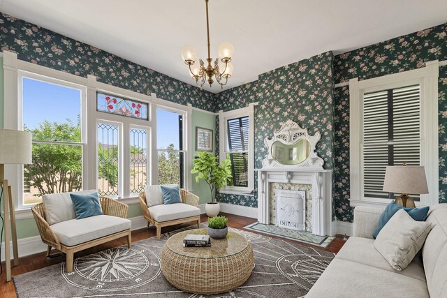 1827 Ball St, Galveston, TX 77550 - living room featuring wallpapered walls, baseboards, wood finished floors, a chandelier, and a fireplace