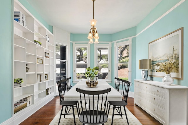 1827 Ball St, Galveston, TX 77550 - dining area with dark wood-style flooring, a chandelier, and baseboards