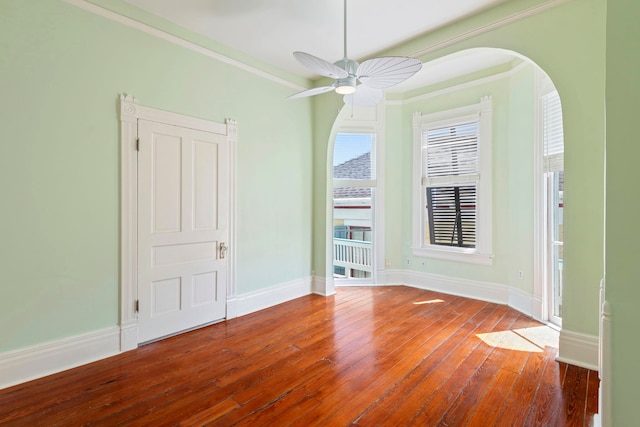 1827 Ball St, Galveston, TX 77550 - unfurnished room with hardwood / wood-style floors, ornamental molding, baseboards, a ceiling fan, and arched walkways