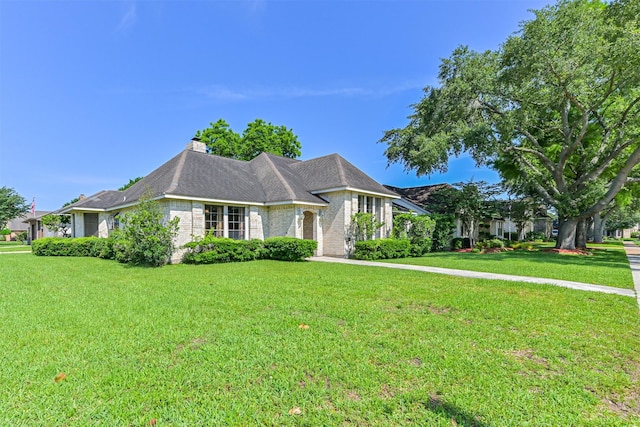 4734 Baywood Dr, Pasadena, TX 77505 - view of front of house featuring a front yard, a chimney, and brick siding