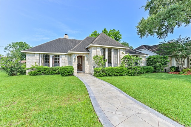 4734 Baywood Dr, Pasadena, TX 77505 - view of front of home featuring a front lawn, brick siding, a chimney, and a shingled roof