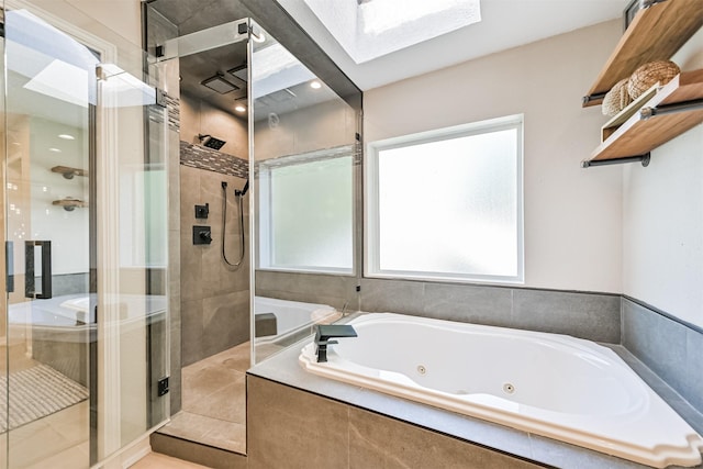 4734 Baywood Dr, Pasadena, TX 77505 - full bathroom with a skylight, plenty of natural light, a shower stall, and a jetted tub