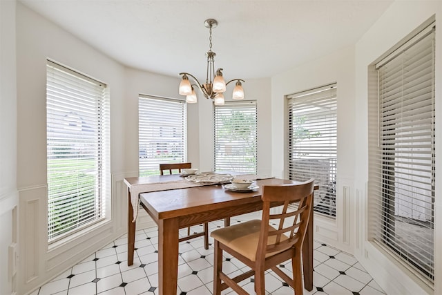 4734 Baywood Dr, Pasadena, TX 77505 - dining space with light floors, a chandelier, and wainscoting