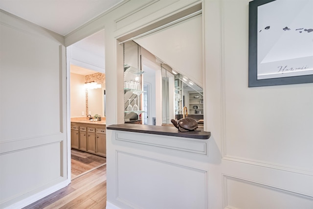 4734 Baywood Dr, Pasadena, TX 77505 - bar area featuring light wood-type flooring and a sink