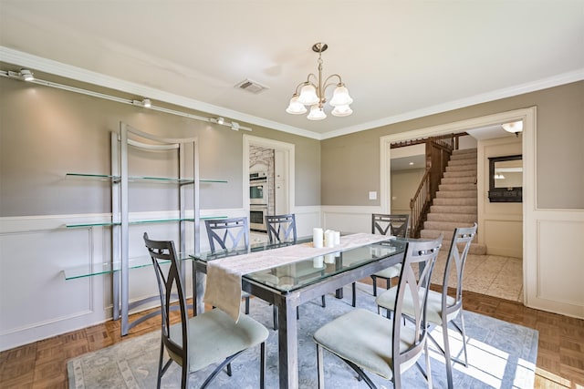 4734 Baywood Dr, Pasadena, TX 77505 - dining area featuring ornamental molding, stairway, wainscoting, a chandelier, and a decorative wall
