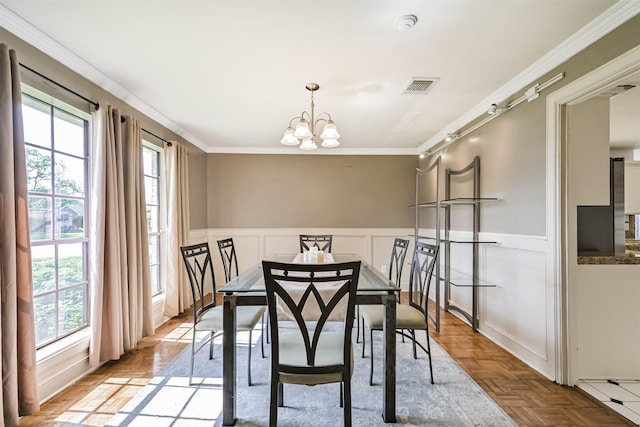 4734 Baywood Dr, Pasadena, TX 77505 - dining room featuring healthy amount of natural light, a chandelier, a decorative wall, wainscoting, and ornamental molding