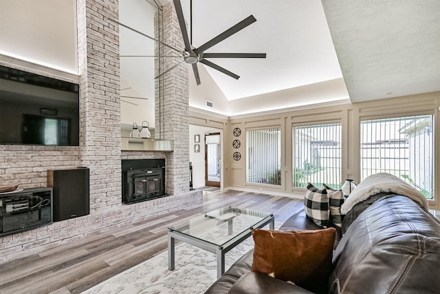 4734 Baywood Dr, Pasadena, TX 77505 - living area with a ceiling fan, wood finished floors, a brick fireplace, and a towering ceiling