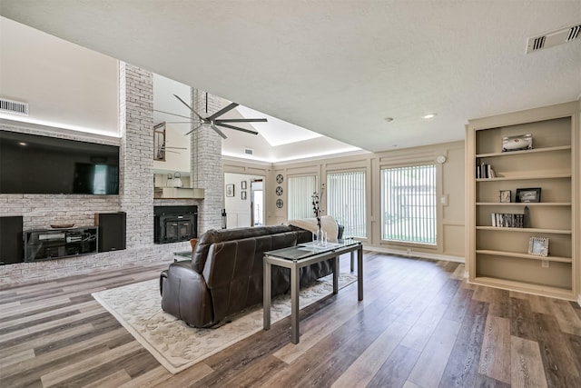 4734 Baywood Dr, Pasadena, TX 77505 - living area featuring a ceiling fan, a fireplace, wood finished floors, built in features, and recessed lighting