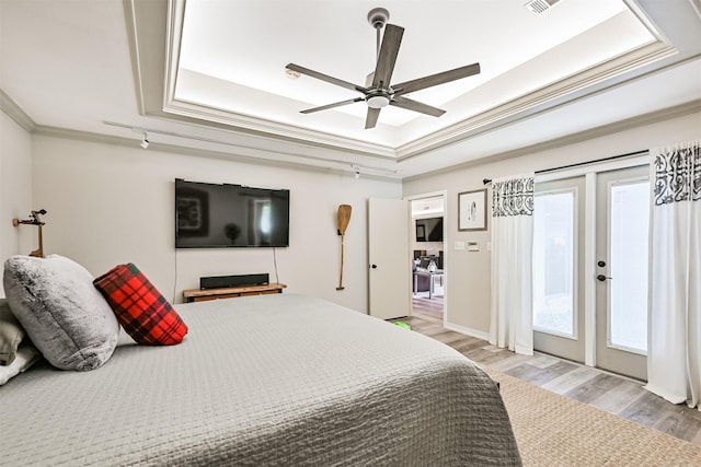4734 Baywood Dr, Pasadena, TX 77505 - bedroom featuring a tray ceiling, light wood finished floors, crown molding, access to outside, and ceiling fan