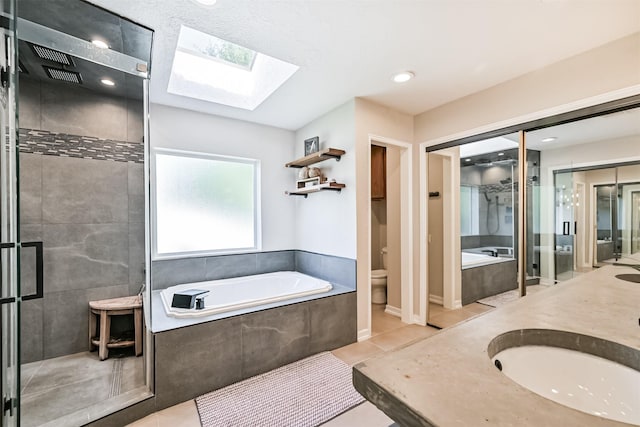 4734 Baywood Dr, Pasadena, TX 77505 - bathroom with a skylight, a shower stall, a garden tub, and toilet