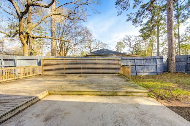 exterior space featuring a fenced backyard and a deck